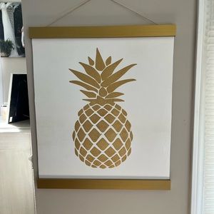 Gold pineapple hanging wall decor. Measures 20” by 23.5”.
